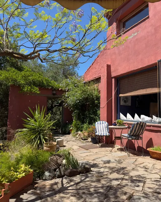 The Forge's terracotta façade and shaded patio in the Casares hills