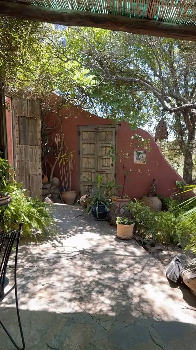 A rustic wooden door along the garden path