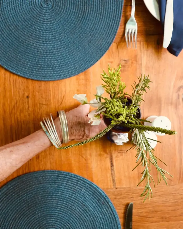 Fresh rosemary and garden flowers on the table
