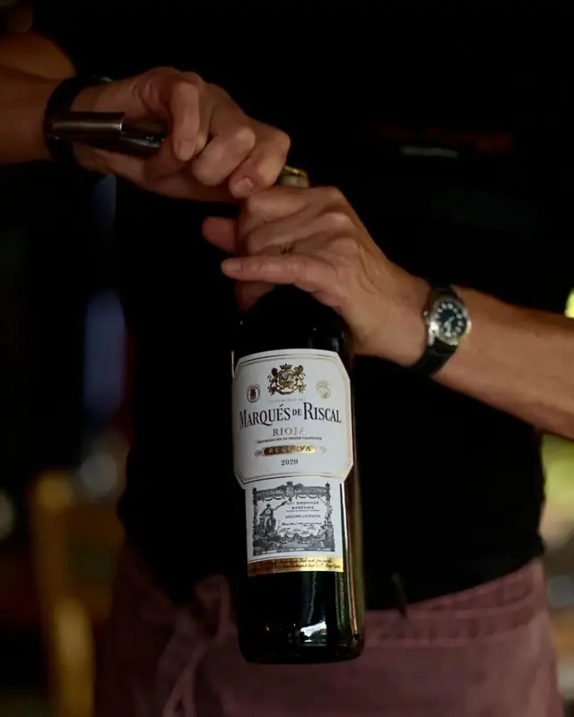 Opening a bottle of Rioja Reserva at the table